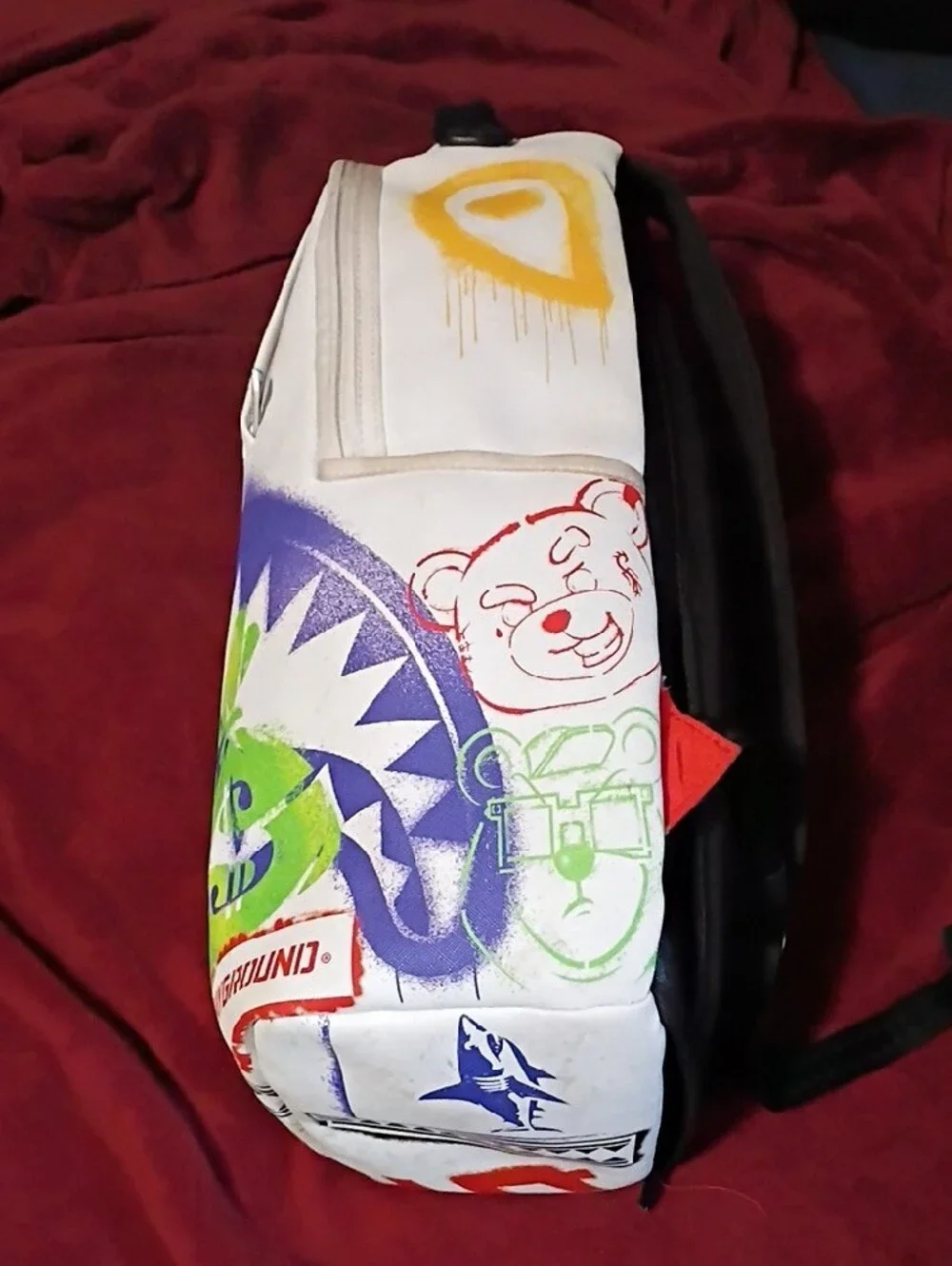 Sprayground White Backpack with Purple Shark Graphic and Green Money-Bag Accents